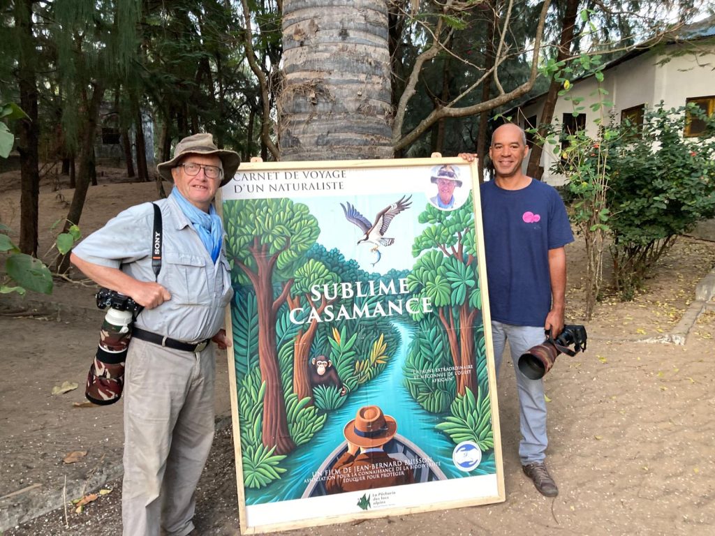 Patrick Tourneur, guide naturaliste à Abéné, devant l'affiche du film Sublime Casamance